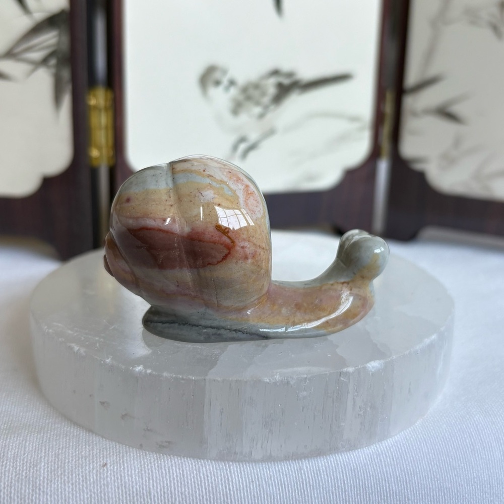 Polychrome crystal snail carving
